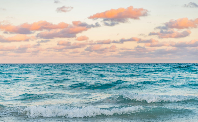 Sea horizon view. Cloudy sky and seascape at summer vacation. Skyscape with sea horizon. Calm horizon view at sea sunrise. Romantic summer vacation