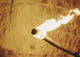 Prehistoric man holding torch