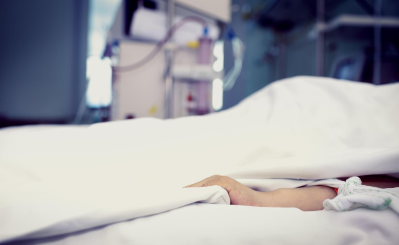 Patient confined to bed in hospital room.