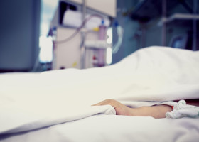 Patient confined to bed in hospital room.