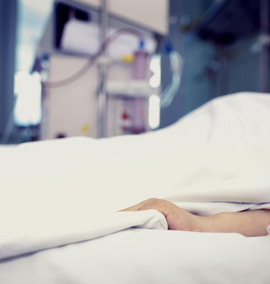 Patient confined to bed in hospital room.