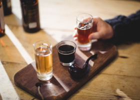 Cropped image of mature man taking a glass of alcohol