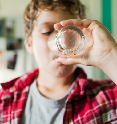 Boy finishing glass of juice