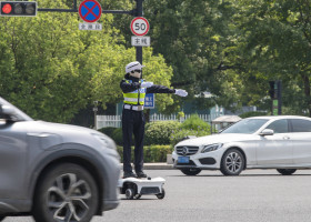 YONGKANG, CHINA - AUGUST 14: A robot traffic police officer assists in directing traffic at an intersection on August 14