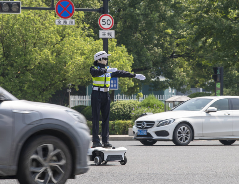 YONGKANG, CHINA - AUGUST 14: A robot traffic police officer assists in directing traffic at an intersection on August 14