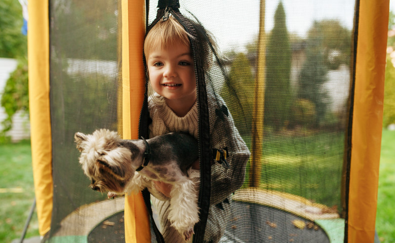 Kid,Holds,Funny,Dog,On,Trampoline,,Best,Friends