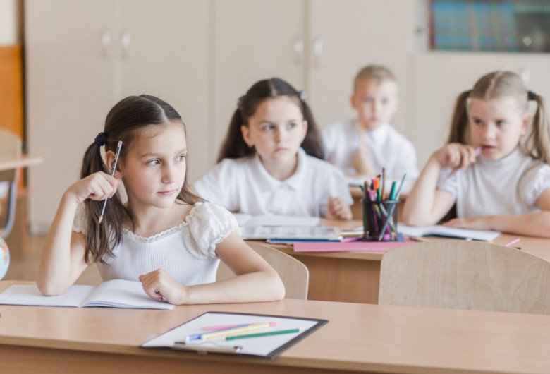 Elevi, în bănci, în clasă