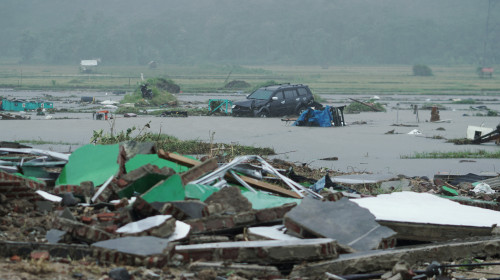 A car is seen among debris after the area was hit by a tsunami in Pandeglang, Banten province