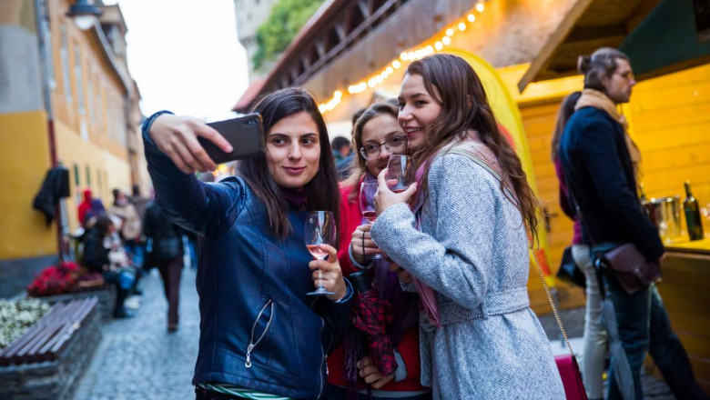 Fete își fac selfie la festivalul vinului