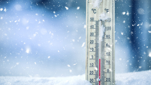 Thermometer,On,Snow,Shows,Low,Temperatures,In,Celsius,Or,Farenheit.