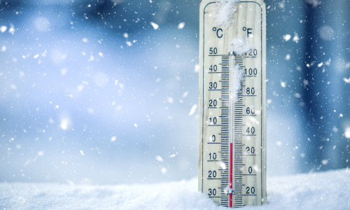 Thermometer,On,Snow,Shows,Low,Temperatures,In,Celsius,Or,Farenheit.