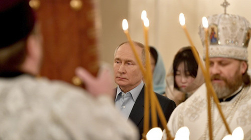 Vladimir Putin at an Orthodox Christmas service with families of troops killed in his war in Ukraine.