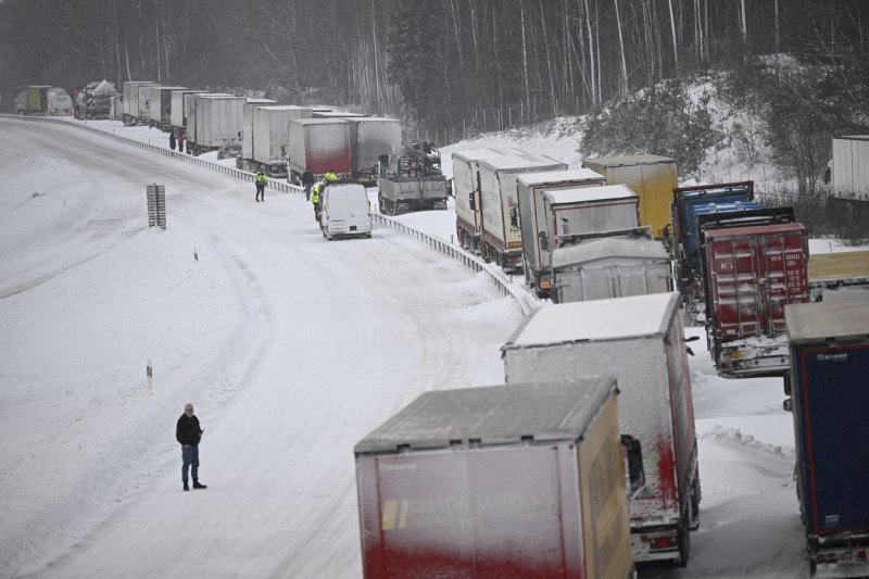 A large number of trucks are stuck on the E22 highway at LinderÃ¶d in southern Sweden on January 4, 2024, where up to 1,000 cars were stuck in queues since the day before due to large amounts of snow that had fallen on the roadway and restricted access, according to the police.,Image: 834154852, License: Rights-managed, Restrictions: Sweden OUT SWEDEN OUT, Model Release: no