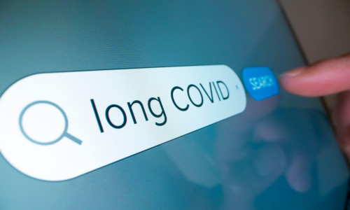 Close-up view of searching information on Long COVID on the internet