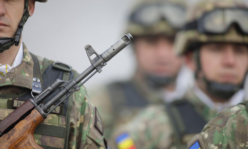 Bucharest, Romania - January 24, 2024: Details with a Romanian army soldier holding an AK 47 assault rifle during a military ceremony at the Monument