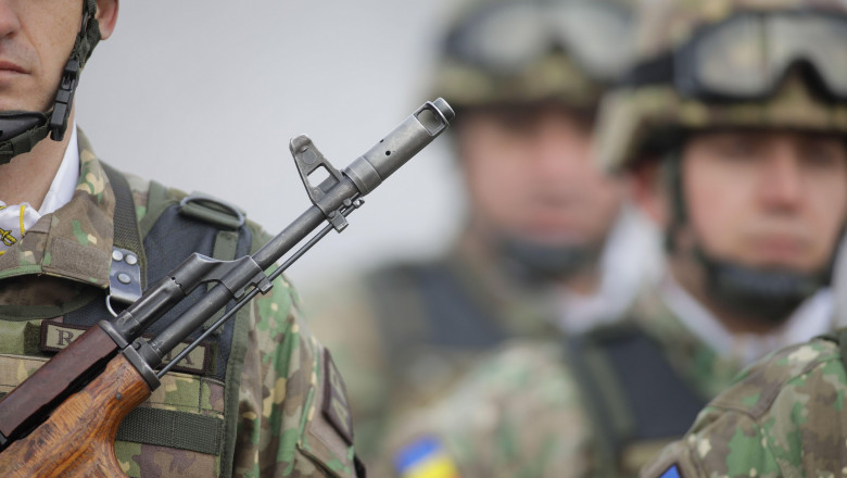 Bucharest, Romania - January 24, 2024: Details with a Romanian army soldier holding an AK 47 assault rifle during a military ceremony at the Monument