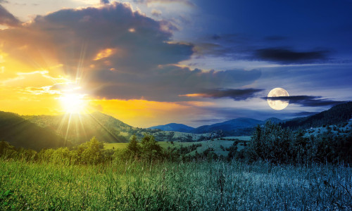 day and night time change concept. Alpine meadow with tall grass on a background of mountains with sun and moon at twilight