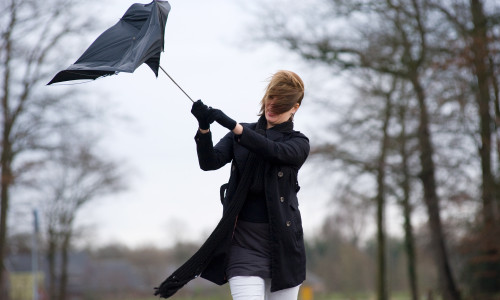 A,Young,Woman,Is,Fighting,Against,The,Storm,With,Her