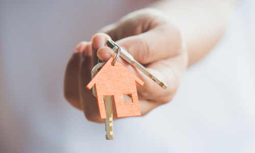 Female,Hand,Holding,House,Key,real,Estate,Agent.