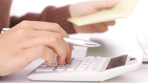 The,Hand,Of,A,Woman,Calculating,Money.,The,Green,Button