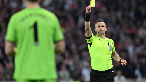 240418 Lille OSC vs Aston Villa goalkeeper Emiliano Martinez (1) of Aston Villa receives a yellow card from referee Ivan