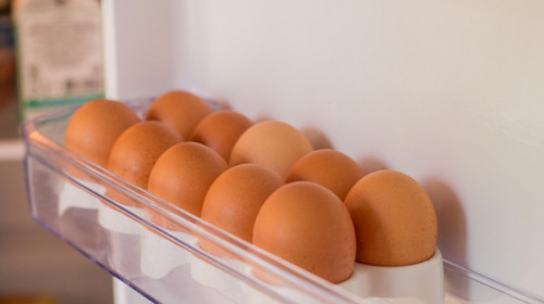 Packing eggs in a cardboard box. Eggs in the fridge.