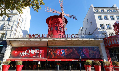 The Moulin Rouge , Paris, France. It is a famous cabaret built in 1889, locating in the Paris red-light district of Pigalle