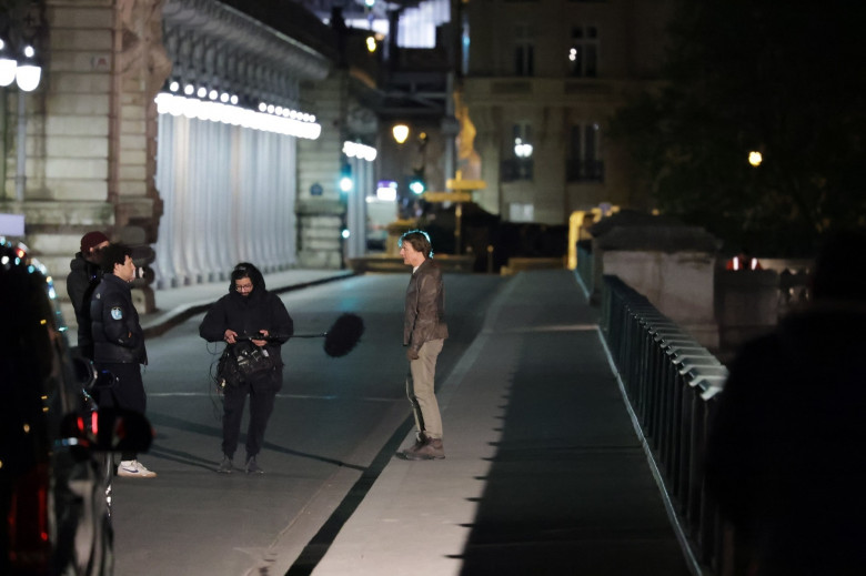 Tom Cruise rides a motorcycle on the Bir Hakeim Bridge for the upcoming Mission: Impossible in Paris