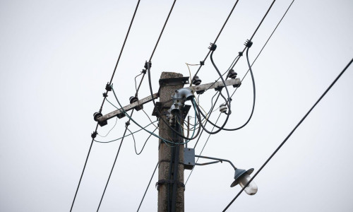 Old power electric line and a Street Lamp, with a power supply cable, made of an obsolete connection system to the public network of electricity taken