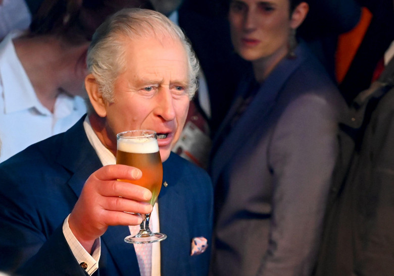 Hamburg, Germany. 31st Mar, 2023. King Charles III of Great Britain holds a self-tapped beer at the ceremonial reception hosted by the British Embassy in Shed 52. The reception marks the end of a three-day visit to Germany by the British king and his wife