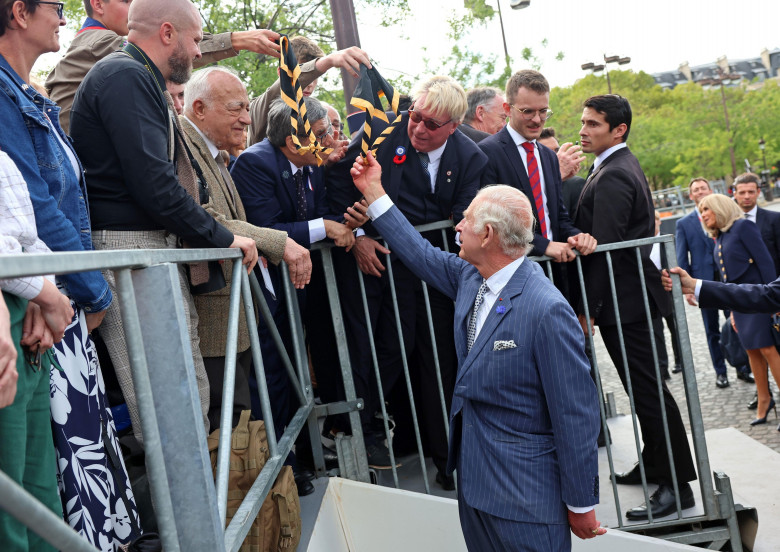 King Charles III shakes hands with representatives of local veteran organisations, scout and guide organisations, and the British School of Paris during a ceremonial welcome at the Arc de Triomphe, Paris, France, at the start of the State Visit. Picture d