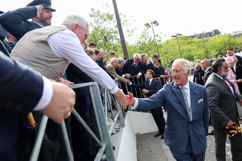 King Charles III shakes hands with representatives of local veteran organisations, scout and guide organisations, and the British School of Paris during a ceremonial welcome at the Arc de Triomphe, Paris, France, at the start of the State Visit. Picture d