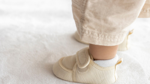 Standing,Baby's,Feet,Wearing,Baby,Shoes,(1,Year,And,2