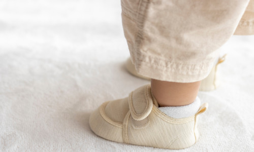 Standing,Baby's,Feet,Wearing,Baby,Shoes,(1,Year,And,2
