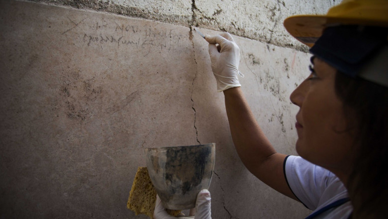 Italy, the ancient Roman city of Pompeii: Archeologists discover a new graffiti that could put an end to scholars' debate about the exact historical date of the eruption of Mt. Vesuvius that destroyed the city in 79 AD