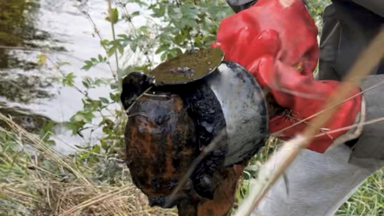 Video footage shows magnet fishers �saving the town� after pulling an unexploded grenade from a canal.