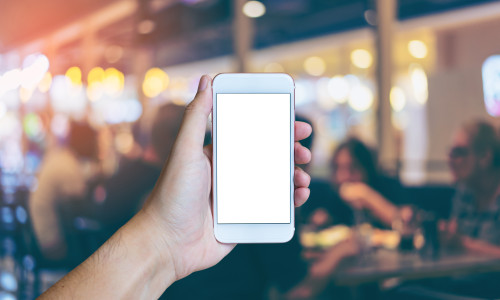 Man's,Hand,Shows,Mobile,Smartphone,With,White,Screen,In,Vertical