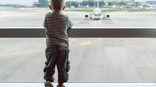 Little,Baby,Boy,Waiting,Boarding,To,Flight,In,Airport,Transit