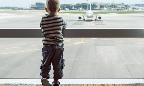 Little,Baby,Boy,Waiting,Boarding,To,Flight,In,Airport,Transit