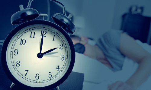 Closeup,Of,An,Alarm,Clock,On,A,Nightstand,Adjusting,Backward