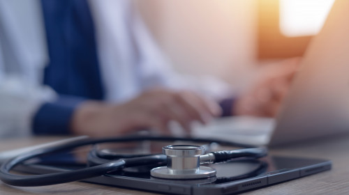 Close-up,Of,Doctor,Working,On,Laptop,Computer,With,Digital,Tablet