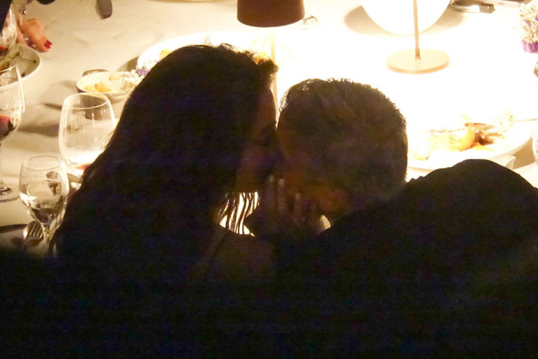 ** STRICTLY NOT AVAILABLE FOR ONLINE SUBSCRIPTION DEALS ** Amal Clooney and George Clooney enjoy a spot of dinner as they pack on the PDA by kissing on Villa D'este at Lake Como.