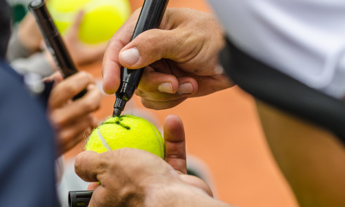 Tennis,Player,Signs,Autograph,On,A,Tennis,Ball,After,Win,