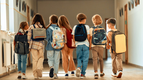 Back,To,School.,A,Group,Of,Schoolchildren,With,Backpacks,Walk