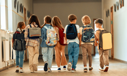 Back,To,School.,A,Group,Of,Schoolchildren,With,Backpacks,Walk