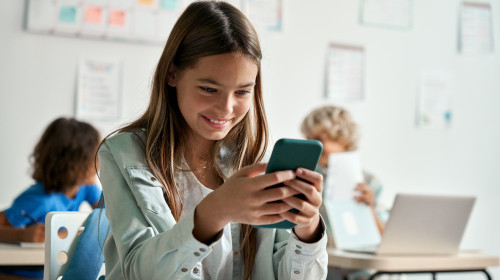 Happy,Latin,Hispanic,Kid,Girl,School,Student,Using,Smartphone,In