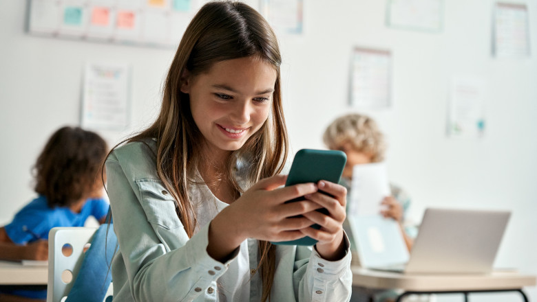 Happy,Latin,Hispanic,Kid,Girl,School,Student,Using,Smartphone,In