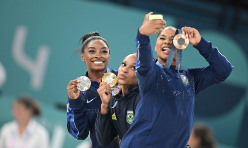 Paris, France. 05th Aug, 2024. (L to R) Silver Medallist Simone Biles of Team United States, Gold Medallist Rebeca Andrade and Bronze medallist Jordan Chiles of Team USA pose during the podium ceremony for the artistic gymnastics women's floor exercise ev