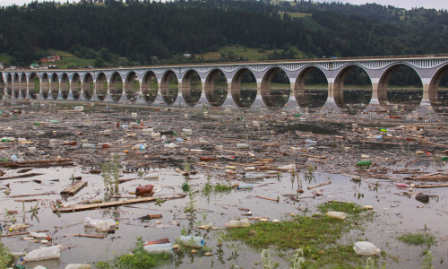 Polluted,Water,With,Plastic,Bottle,Debris,At,Bridge,Over,Bicaz