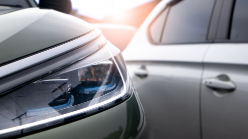 Close,Up,View,Of,Modern,Car,Headlight,With,Sunbeams.,Traffic